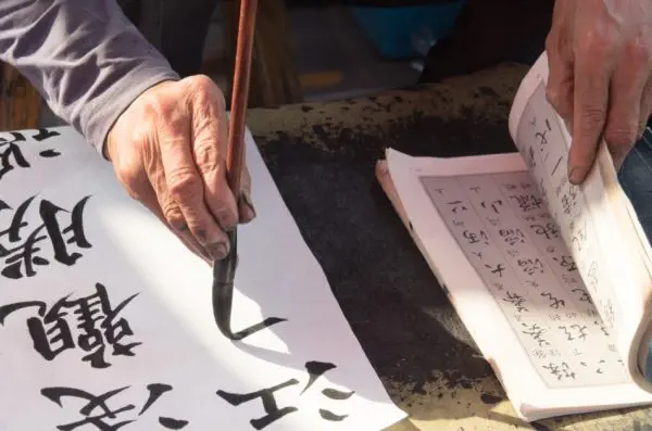A calligrapher hand writing chinese calligraphy.
